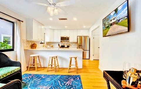 Best of both; spacious island for prep, TV for shows while you cook.
