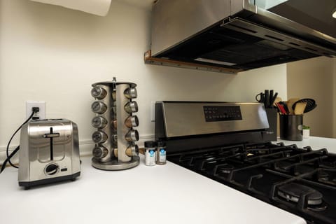 Fully equipped kitchen featuring stove, oven, fridge, and toaster