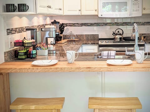 The breakfast bar is granite and pine with seating for four adults.