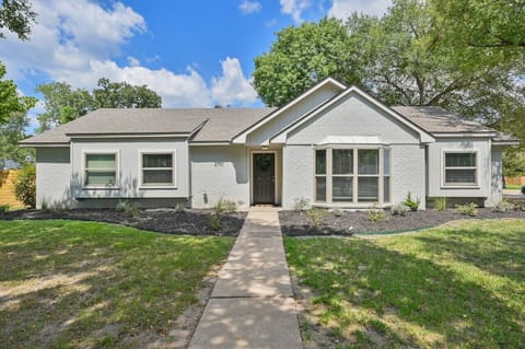 The exterior showcases a welcoming long sidewalk leading to the front entrance.