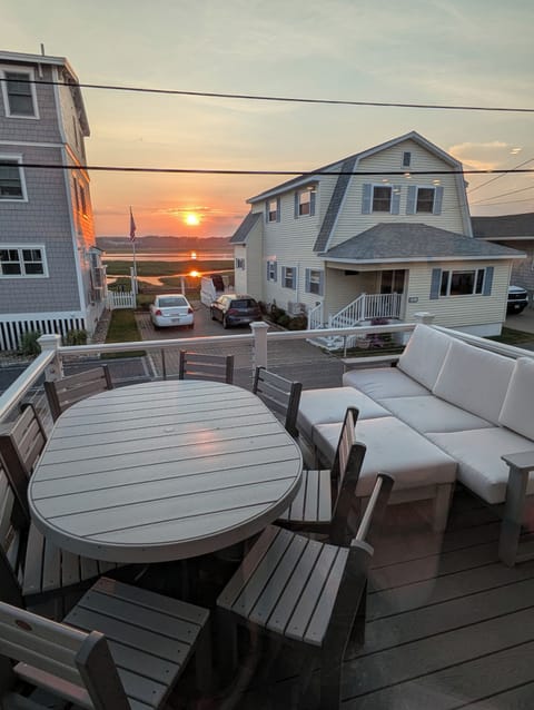 Outdoor eating & lounging space with sunsets over the harbor