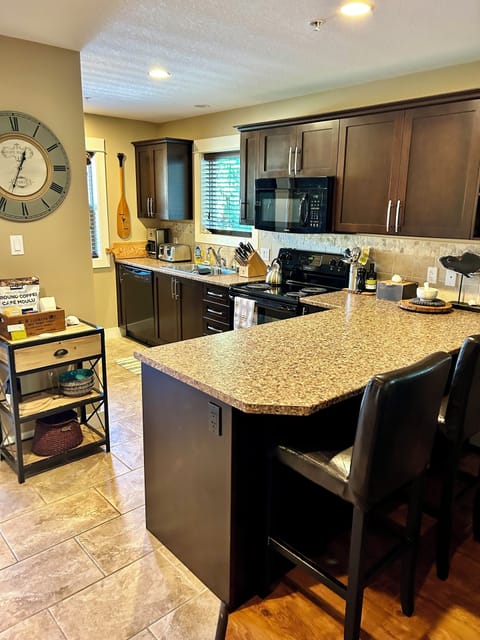 Fully equipped kitchen with counter seating.
