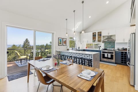 Huge open-concept living/ dining/ kitchen area with views of Lake Washington.