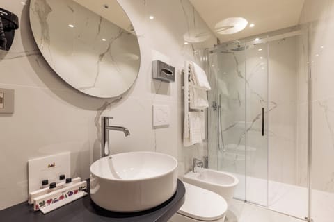 Deluxe Double Room, Courtyard View | Bathroom | Shower, hair dryer, towels, soap