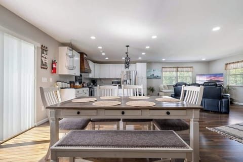 Gather around and enjoy a family meal in our open-concept space that seamlessly connects the dining area, kitchen, and living room, making it perfect for quality time together.