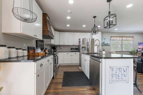 The kitchen is fully equipped with an abundance of dishes, cookware, stainless steel appliances, and ample storage, ensuring you have everything you need to prepare and enjoy meals during your stay.