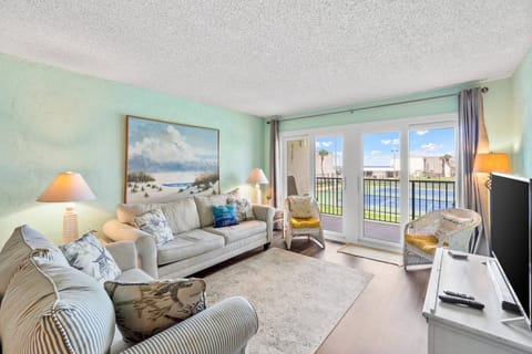 Living area over looking the tennis courts and pond, with Gulf views in the background! 