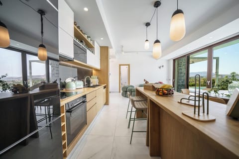 Left Building: The kitchen is fully equipped with modern appliances, making self-catering a breeze, and features an island with four stools