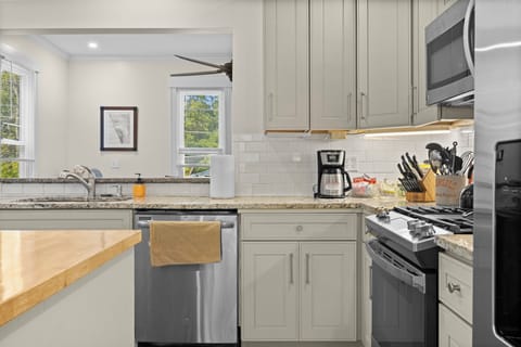 KITCHEN:  The home has a newly-renovated kitchen with a large kitchen island and all appliances, including a dishwasher.  There is also a good supply of cooking and dining utensils provided.