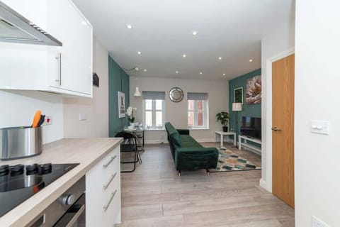  Open-plan kitchen and living area with modern amenities, stylish decor, and plenty of natural light—perfect for cooking, relaxing, or planning your next day out.