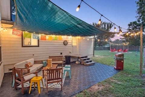 patio area with cozy lounge seating, bbq, and backyard view