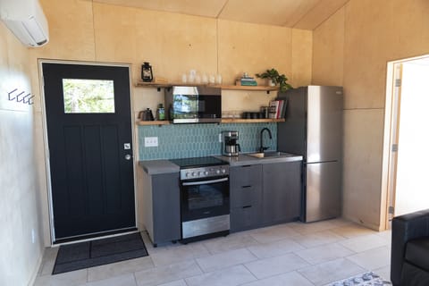 Full kitchen includes an electric range/stovetop, fridge, and microwave.