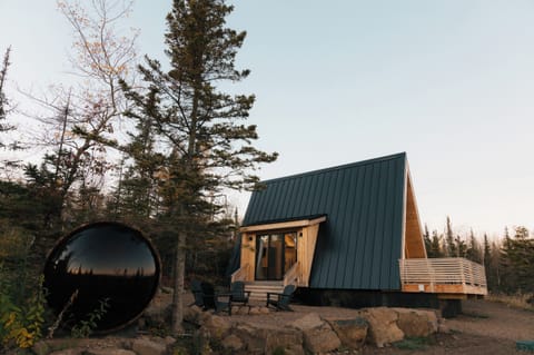 Outdoor living space with panoramic barrel sauna overlooking Lake Superior