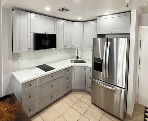 New kitchen including cooktop, microwave, fridge