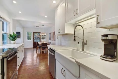 Fully equipped kitchen with farm sink, Keurig, and direct dining access.