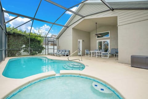 Relax by the screened-in pool and spa area with ample seating for outdoor enjoyment.