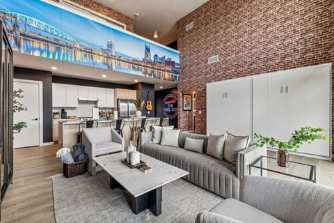 Living room with Smart TV, two queen Murphy beds, and private patio access