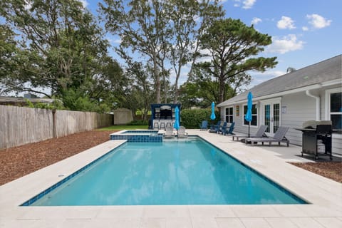 Pool with heated spa, bar with TV and mini fridge, gas grill, chairs/umbrellas