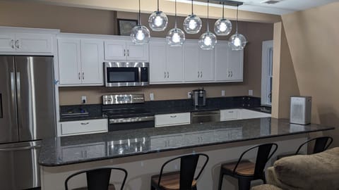 Kitchen, stainless steel appliances, granite counters, island with 4 chairs