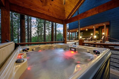 Relax in the private hot tub, tucked away in the secluded backyard—a perfect spot to unwind | Timberline, Broken Bow, Oklahoma | Voyax Luxury Vacation Rentals