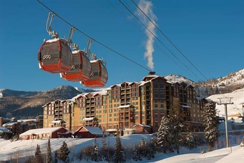 Experience the thrill as you glide up the mountain in the gondola, surrounded by stunning snow-capped peaks.