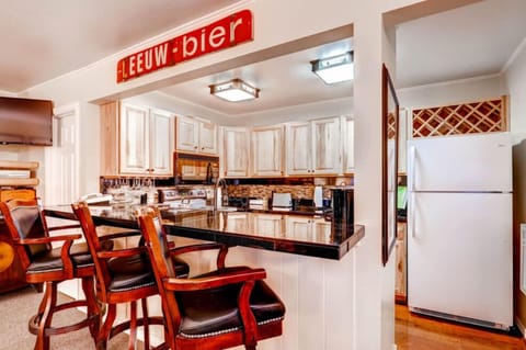 Bright dining area adjacent to a fully equipped kitchen.