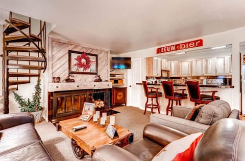 Stylish living room with cozy seating and open dining area.