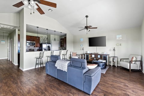 Large open space that connects to the kitchen with a bar seating area. 