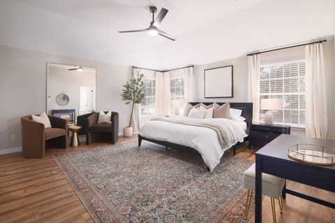Unwind in this tranquil bedroom featuring a luxurious king-sized bed, dressed in soft, high-quality linens that promise a restful night's sleep. The calming ambiance is enhanced by ambient lighting, creating a serene atmosphere perfect for relaxation