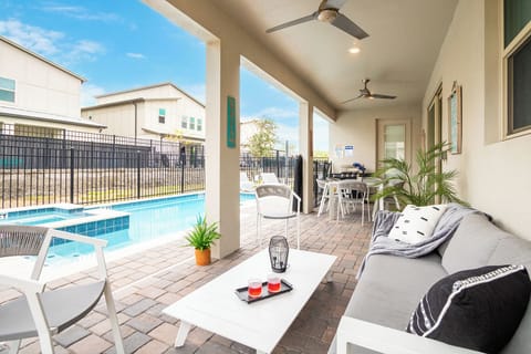 Relax by the pool in a breezy, cozy patio with stylish outdoor seating.