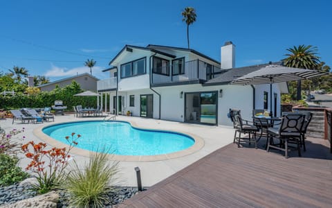 Backyard with pool, dining area, lounge area and bbq