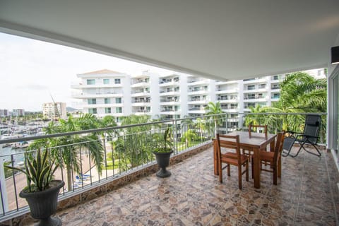 Spacious balcony with waterfront views and cozy dining area