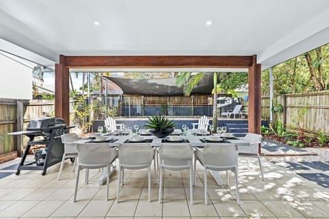 Undercover outdoor dining area with BBQ and seating for 10.