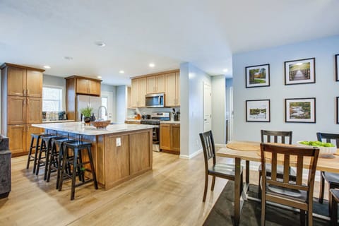 The kitchen has plenty of cabinet space and an area reserved for pantry items. It is open to the dining area with seating for 6 at the table and 4 at the breakfast bar on the island.