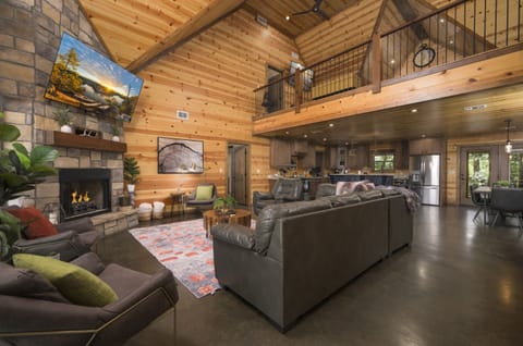 Spacious main floor living room featuring a cozy seating area and smart TV