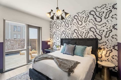 The third bedroom offers a cozy king bed, direct terrace access, dresser, smart TV, and soft linens. Great for families or friends traveling together, this room combines comfort and privacy in the heart of Downtown New Orleans.