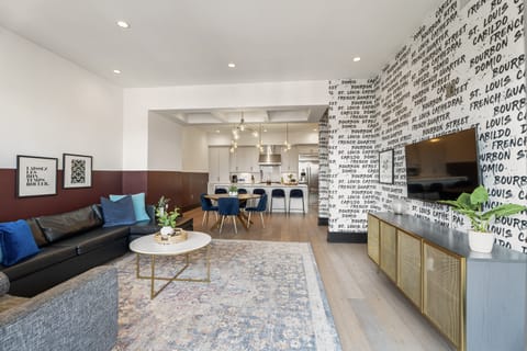 Relax in the living area with a smart TV, stylish seating, and a sleeper sofa for extra guests. Perfect for families or group stays in New Orleans, this inviting space is ideal for movie nights or recharging after a day in the city.