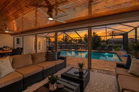 As daylight fades, the backyard transforms into a tranquil retreat perfect for evening swims, outdoor dining, and unforgettable vacation memories.