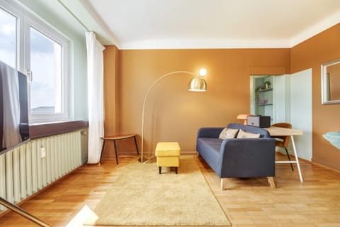 Spacious and stylish living area featuring contemporary decor, ample natural light, and a perfect spot to unwind or work.