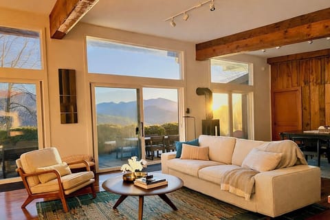 The living room has stunning views of Mt Mitchell and because the house was built passive solar it warm, cozy, or breezy and cool often without the heat or air on. Large sliding doors open to a private patio with grill, herb garden, and fire pit.