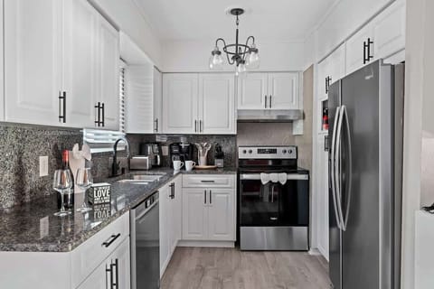 Full view of the kitchen featuring beautiful white cabinets and sleek stainless steel appliances, perfect for all your culinary needs.
