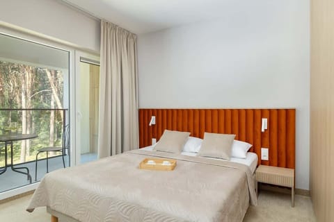 Bright living room with forest view – Relax with nature right outside your window.

