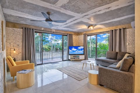 Open plan gorgeous living space with views to the trees across the road. The beach is just on the other side of these trees.