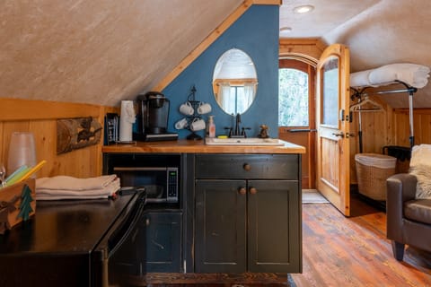 3rd bedroom in garage equipped with Keurig, microwave & fridge.