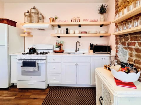 [Kitchen Area] Cook up culinary delights in our sleek and modern kitchen.
