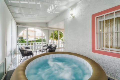 Jacuzzi with hot water in a glass-enclosed area to keep you warm.