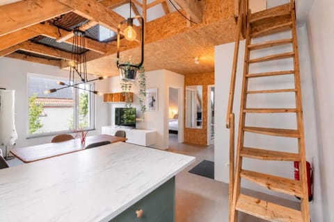 Bright living space with TV and open attic layout 