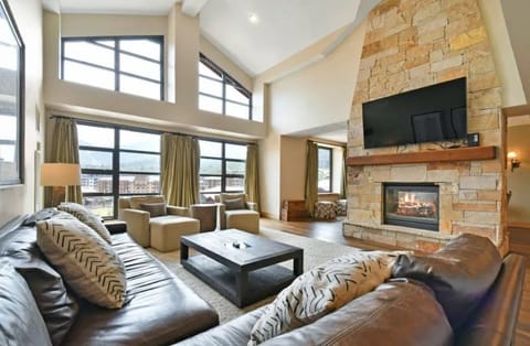 Cozy living room with a stone fireplace and plush seating.