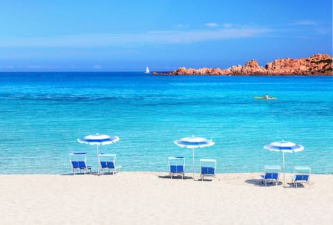 On the beach, white sand, free beach shuttle, beach umbrellas