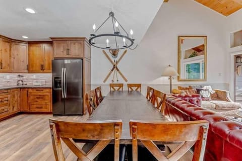 Dining Room: 9-person dining table, centrally located between kitchen and living room